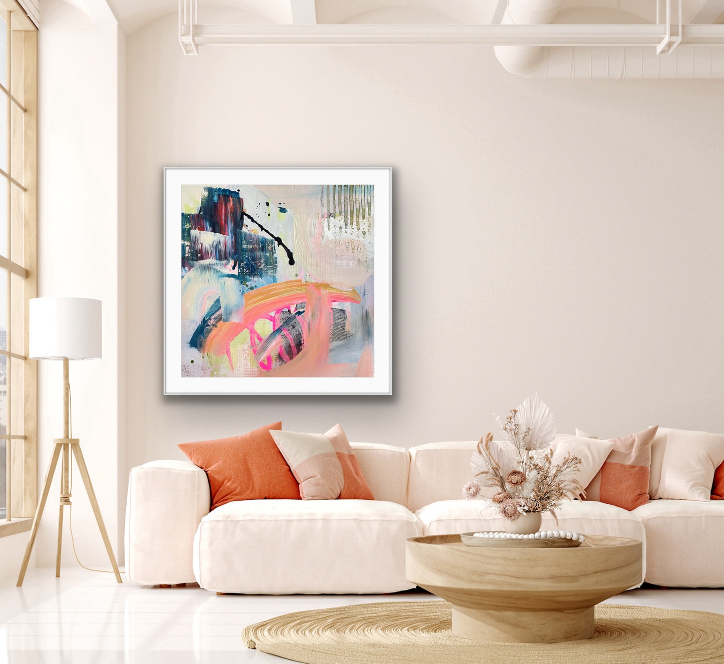 Modern living room with a colorful abstract framed Giclee print "Chaos" on the wall, white sofa, and wooden coffee table.