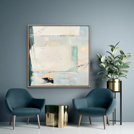 Large abstract framed canvas print on a grey wall above two contempoary chais and a plant on a stand.