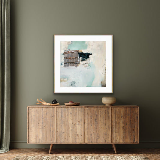 Abstract art print "Seafoam's Echo" by Alison Gilbert Art, on a wall above a wooden sideboard with decorative items.