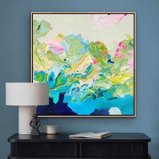 Abstract Alison Gilbert canvas print 'Turbulence' with vibrant colors on a wall above a black console table.