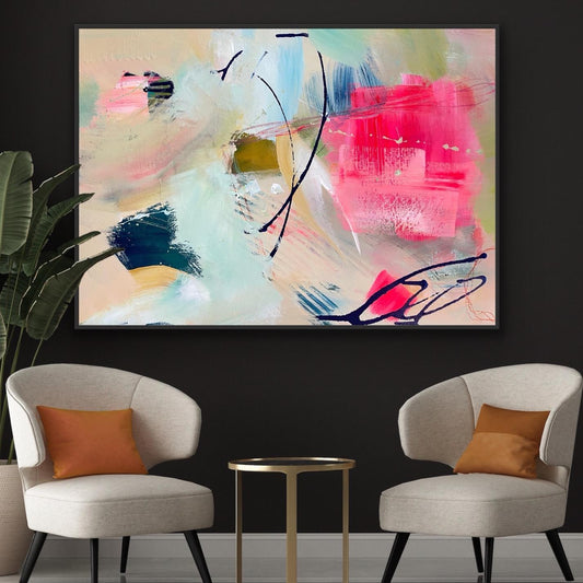 Abstract Alison Gilbert canvas print 'Unexpected Arrival'on a black wall above two chairs with orange cushions.