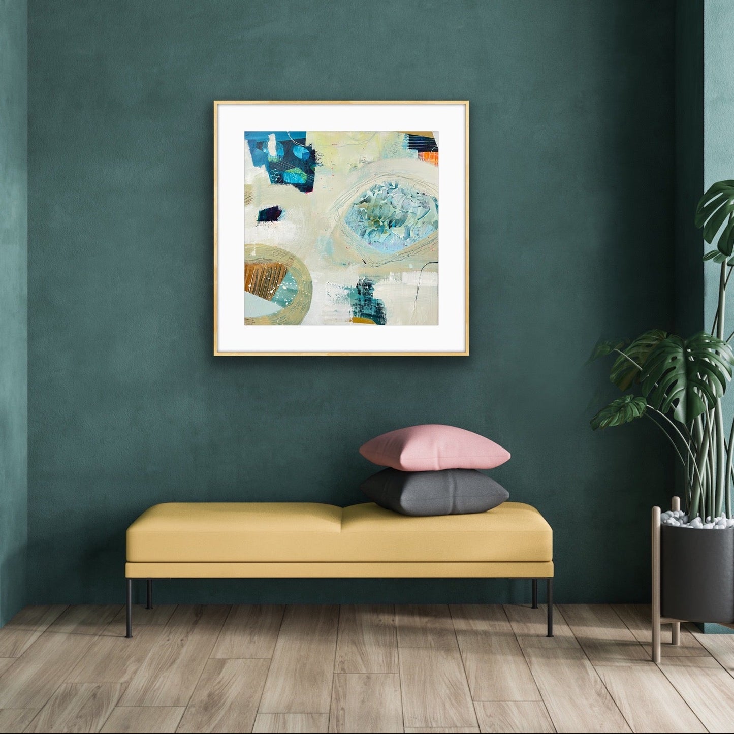 Modern interior with a yellow bench, colorful pillows, and a framed abstract art print, "Beachcombing" by Alison Gilbert Art, on a green wall.