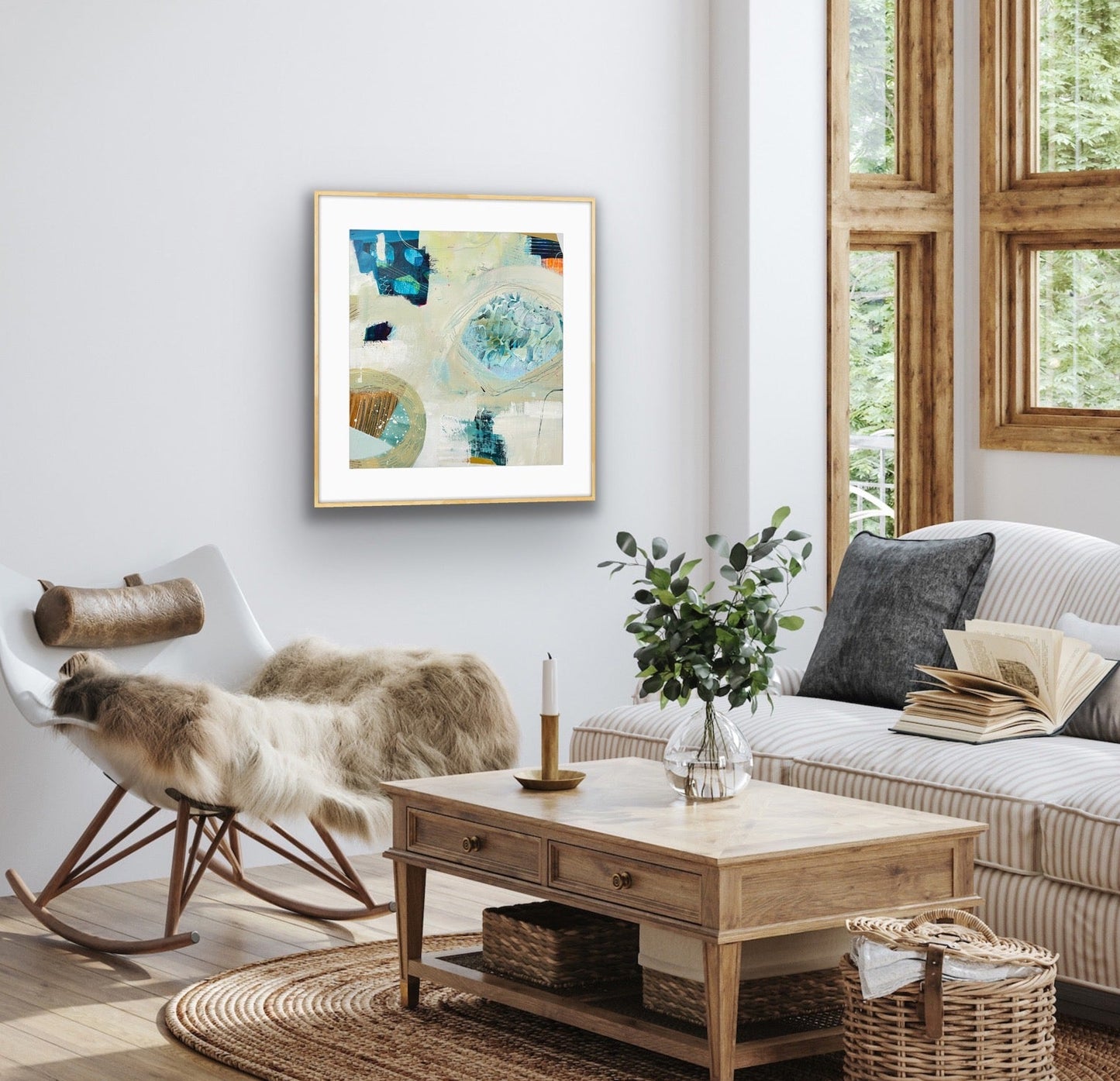 Living room with a couch, coffee table, and abstract art print "Beachcombing" on the wall.