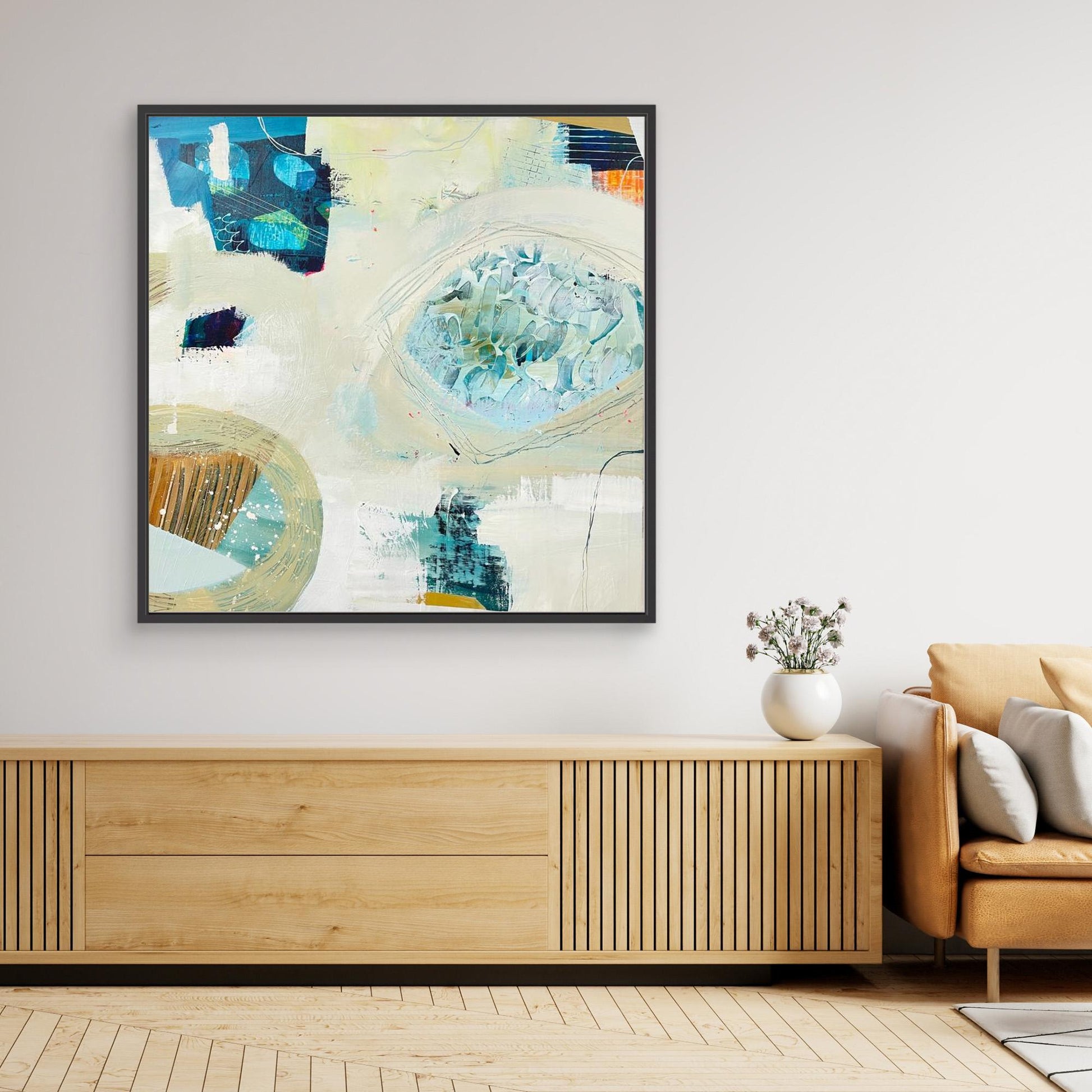 'Beachcombing'  abstract framed canvas print on a wall above a wooden console table in a living room.
