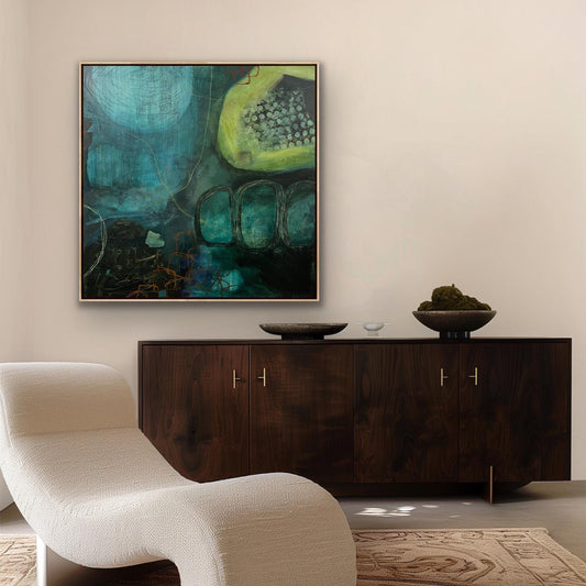Modern living room with abstract Alison Gilbert canvas print 'Behind the Waterfall' , wooden sideboard, and white chair.