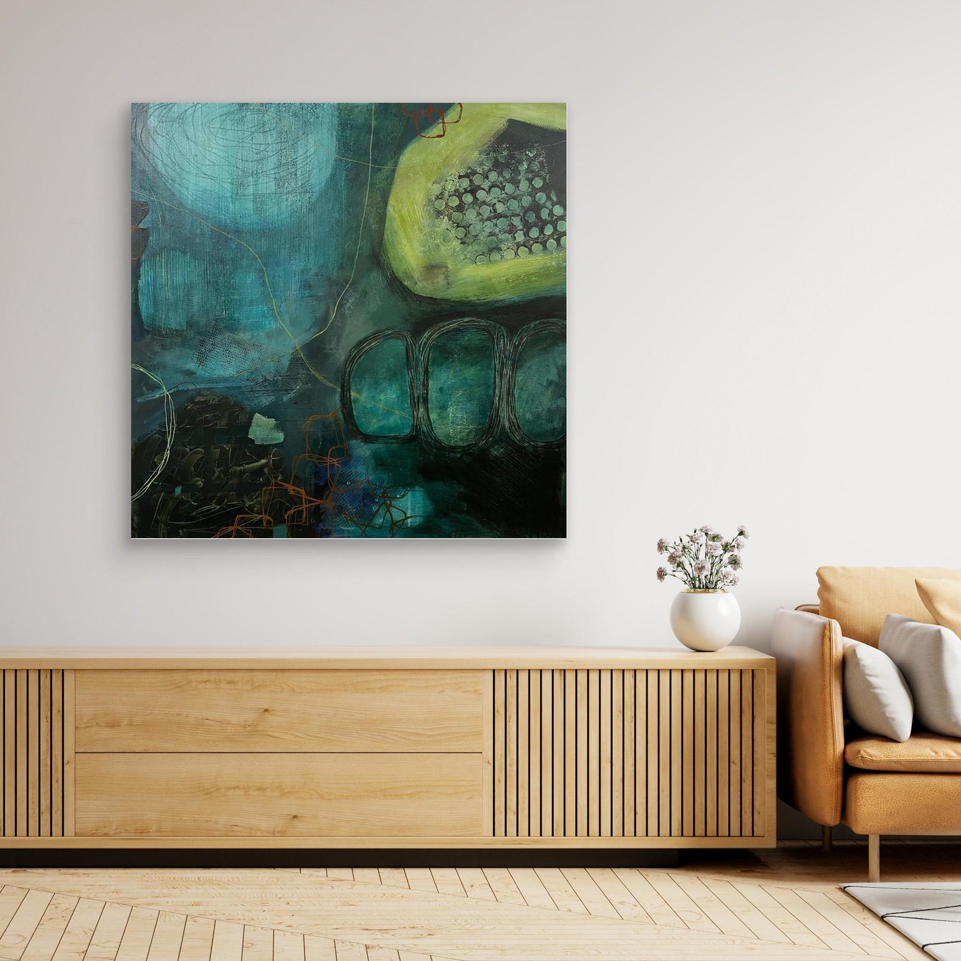 Abstract canvas print 'Behind the Waterfall' on a wall above a wooden console table in a living room.