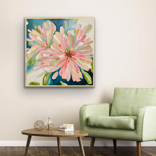 Floral Alison Gilbert canvas print 'Bloom Large' on a wall above a green armchair in a living room.