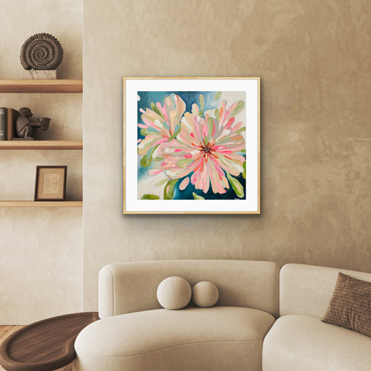'Bloom Large' Framed Print on Paper on a wall above a beige sofa in a living room.