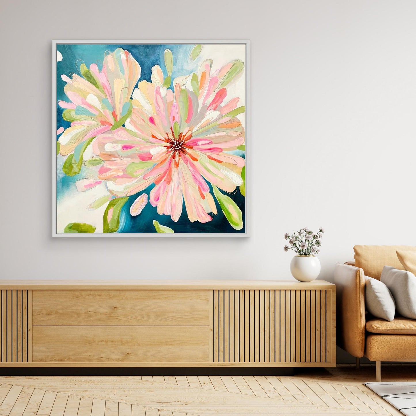 Abstract canvas print 'Bloom Large' on a wall above a wooden console table in a living room.