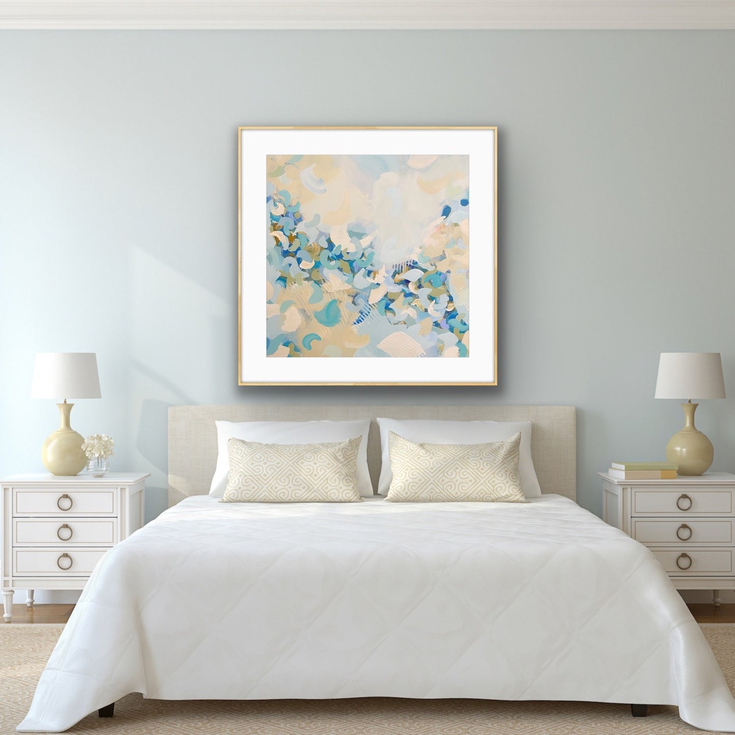 Bedroom with light blue abstract art print "Blue Blossom" by Alison Gilbert Art above the bed, two lamps on either side, and white nightstands.