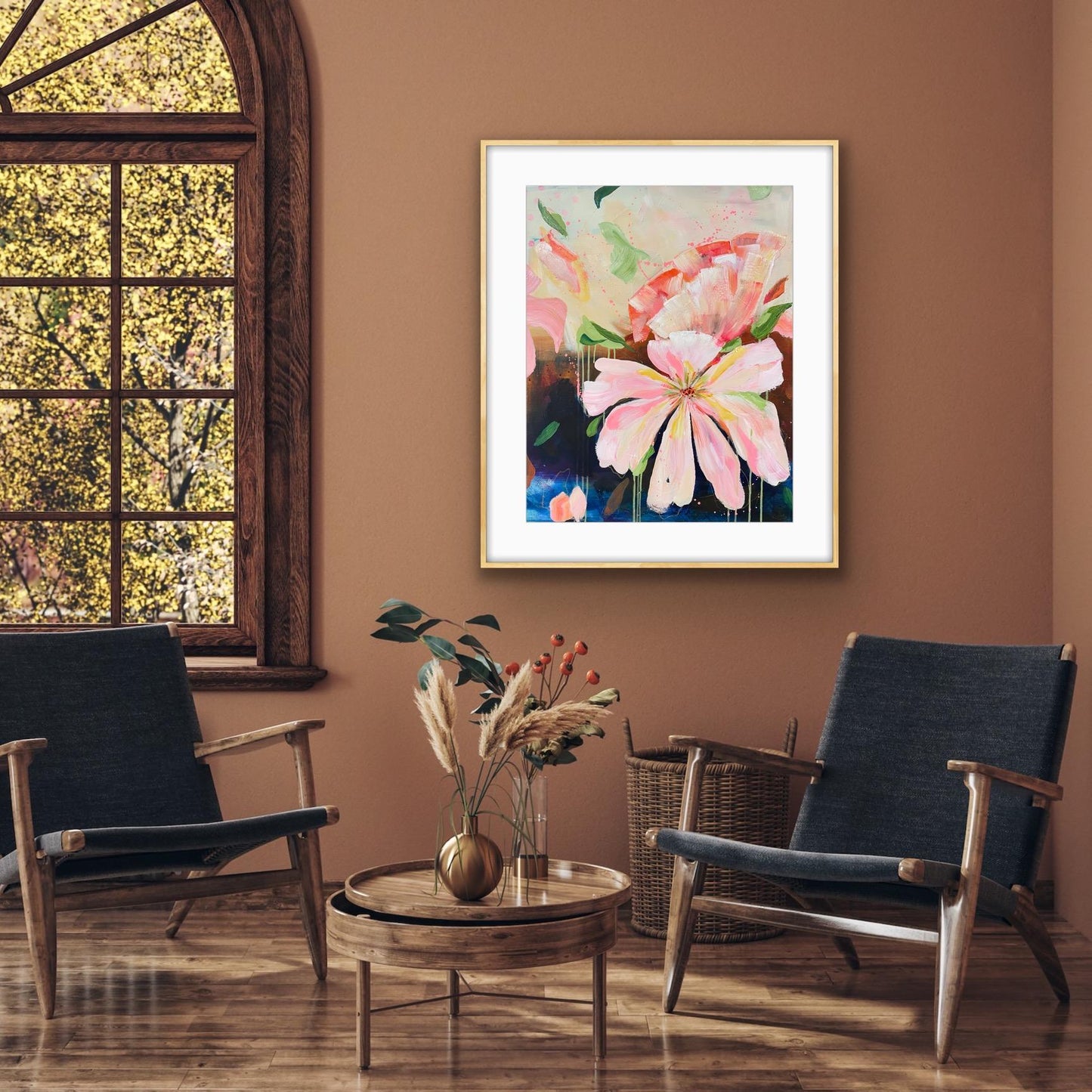 Living room with floral artwork 'Botanical Dream' Framed Art Print on the wall, two dark blue chairs, and a wooden table.