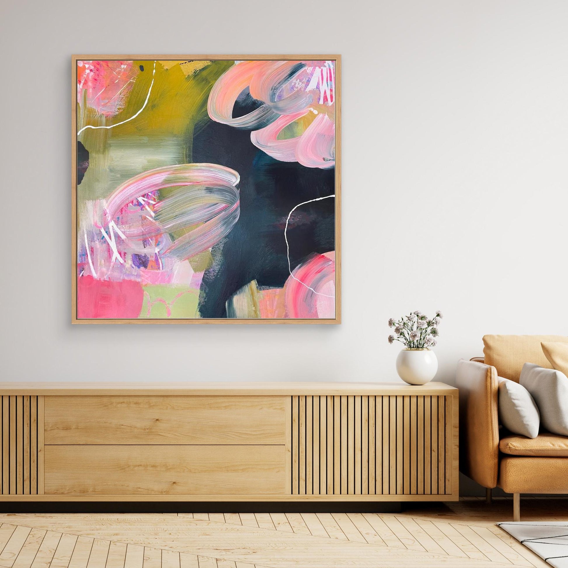 Abstract Alison Gilbert canvas print 'Bubblegum' in a modern living room setting with a wooden cabinet and sofa.