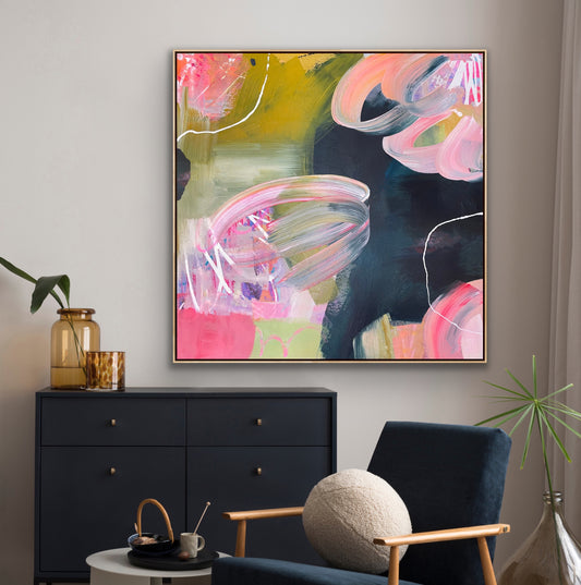 Abstract Alison Gilbert canvas print 'Bubblegum' on a wall above a black cabinet in a living room.
