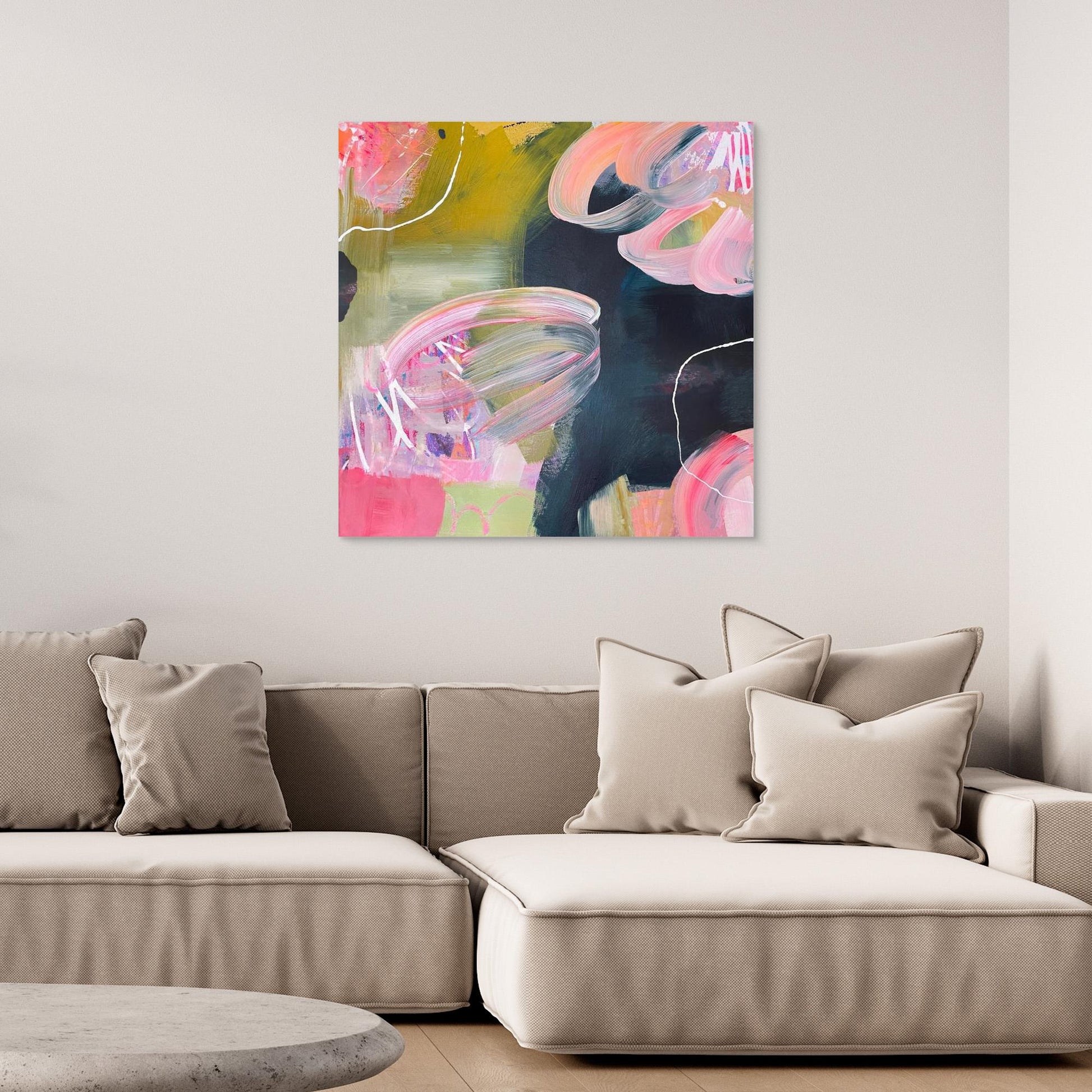 Abstract Alison Gilbert canvas print 'Bubblegum' on a wall above a beige sofa with decorative pillows.