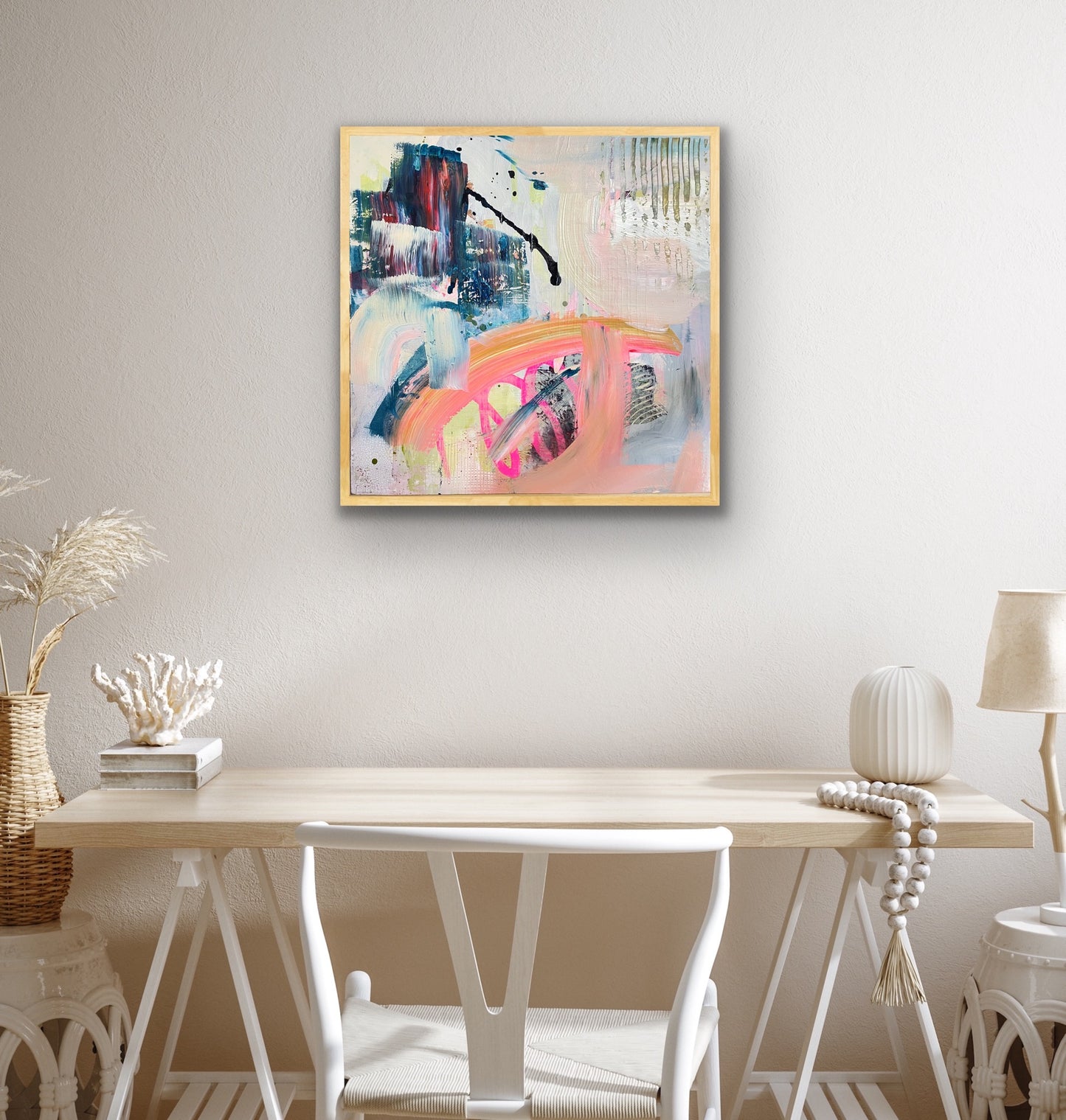 Abstract Alison Gilbert canvas print 'Chaos' on a wall above a wooden table with decorative items.