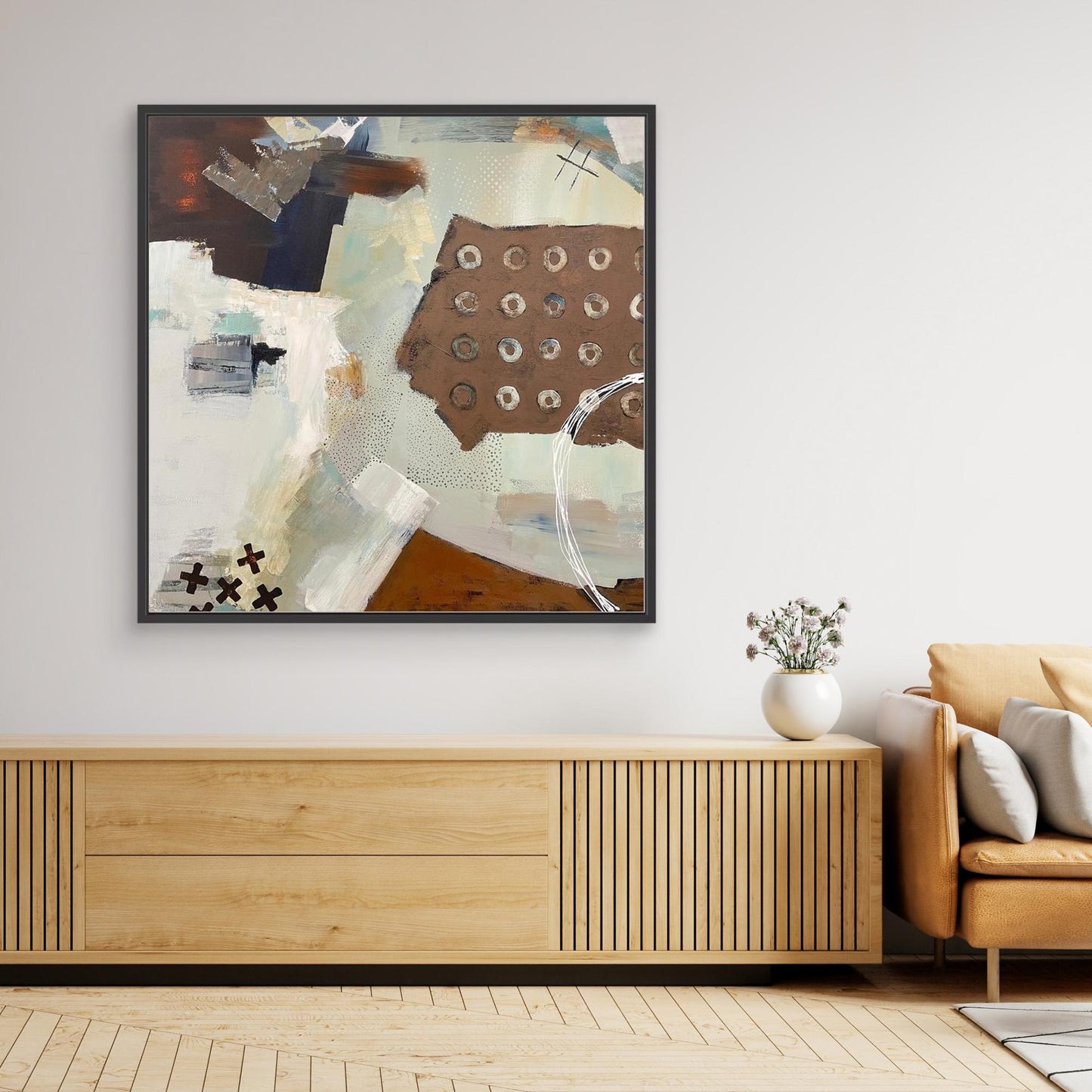 Abstract Canvas Print 'Echoes" on a wall above a wooden console table in a living room.