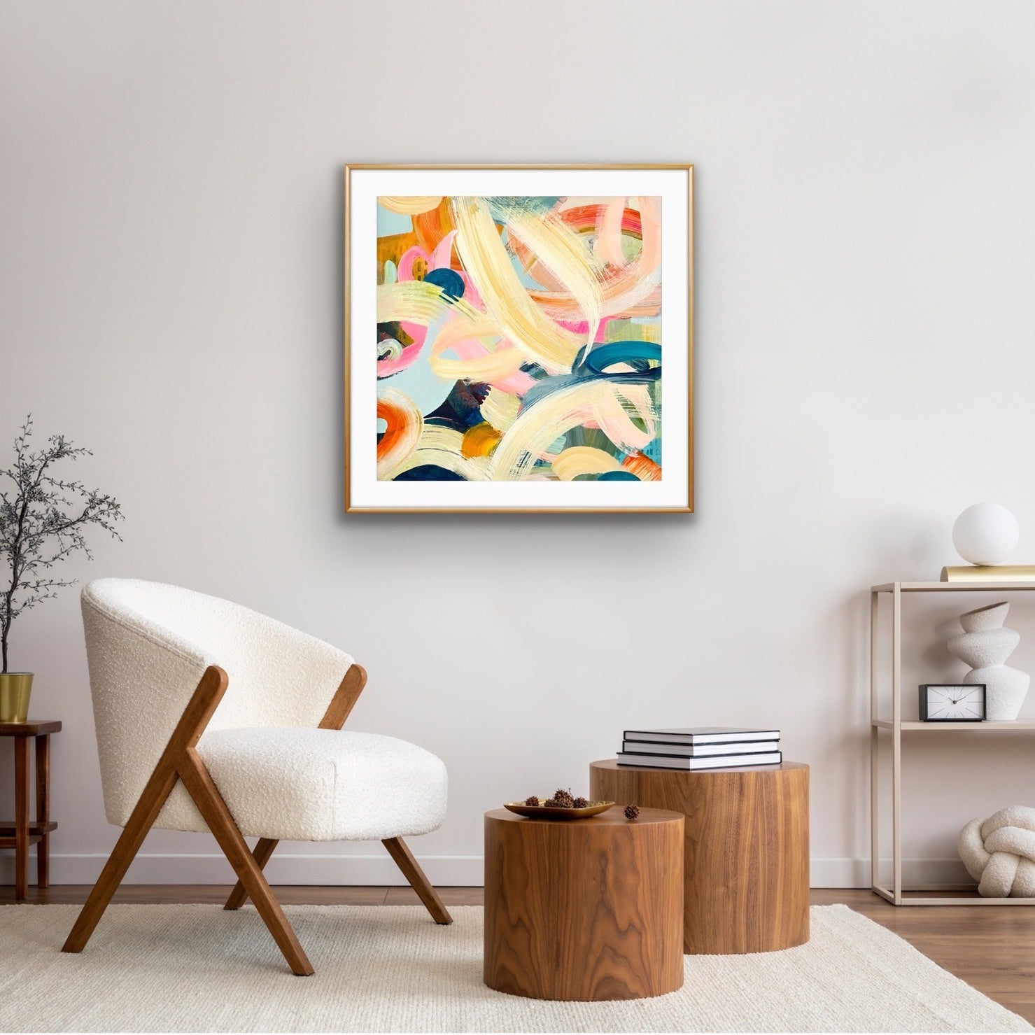 Modern living room with a colorful abstract painting on the wall, a white armchair, and wooden side tables.