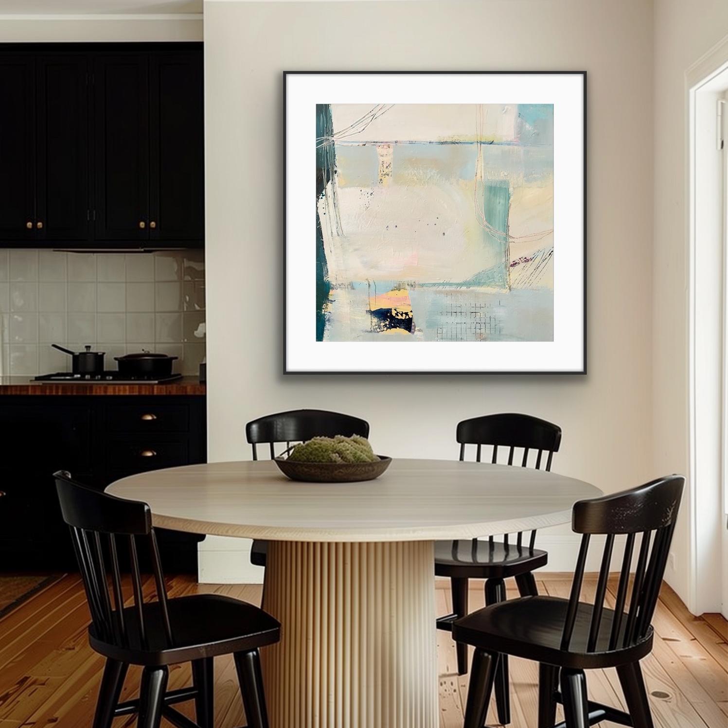 Dining area with a round table and black chairs, featuring a framed art print on paper, 'Harbour,' on the wall.