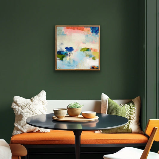 Modern interior with a green wall, colorful abstract canvas print 'Lost in the Moment', and a seating area with a table and chairs.