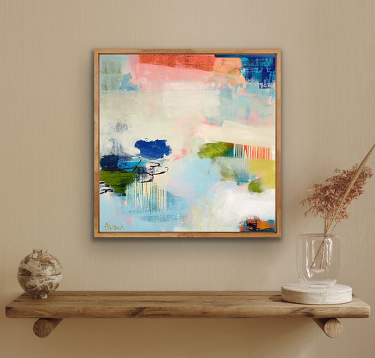Abstract print by Alison Gilbert Art on a wall above a wooden shelf with decorative items.