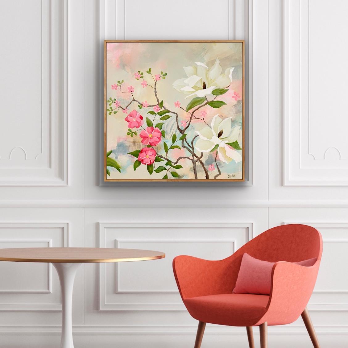Floral May Magnolias Canvas Art Print on a wall above a coral coloured chair and a table.