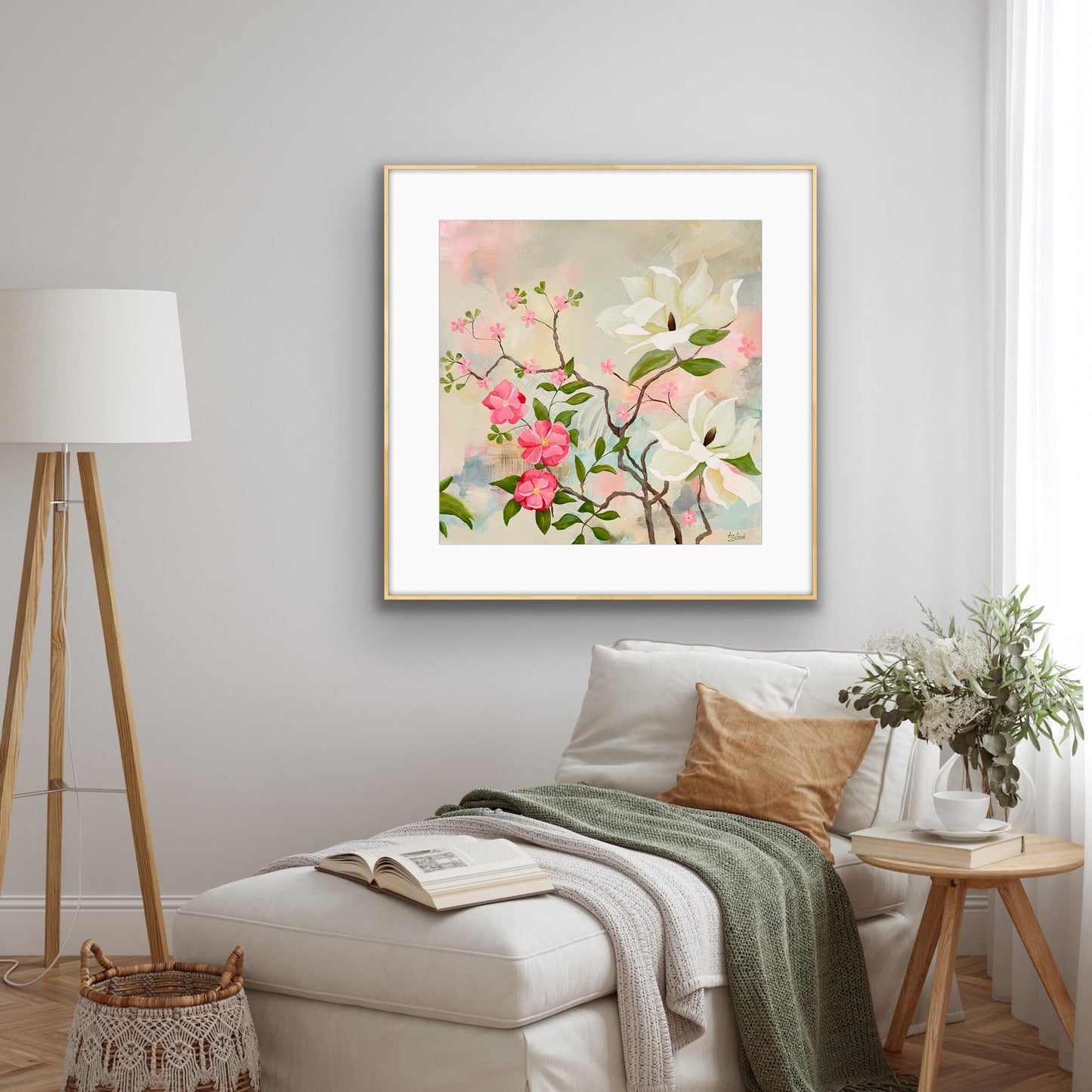 Floral painting on a wall above a sofa with a lamp and side table in a living room.