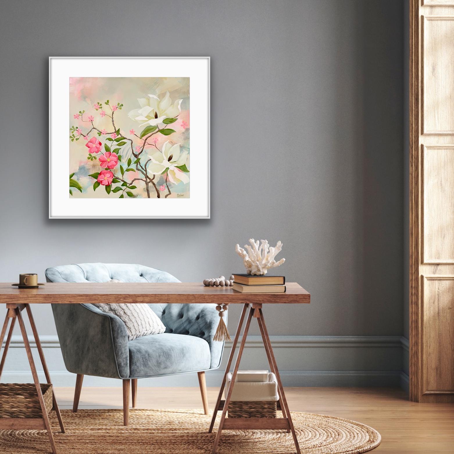 Framed floral Print 'Maytime Magnolias' artwork on a gray wall above a wooden desk with a chair.