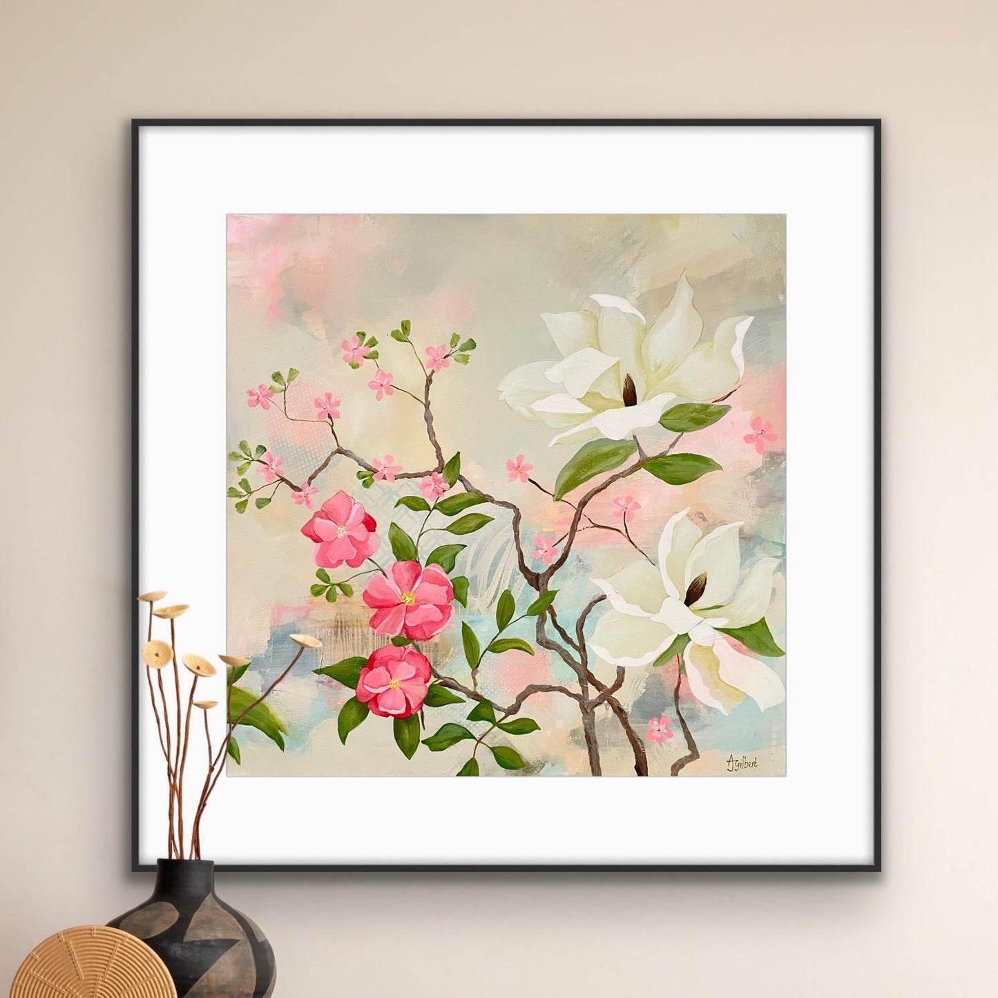 Framed floral artwork 'Maytime Magnolias' with pink and white flowers on a beige wall.
