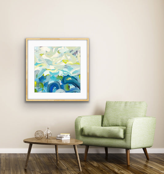 Framed abstract print "Outward Expression" on a wall above a green armchair in a living room.