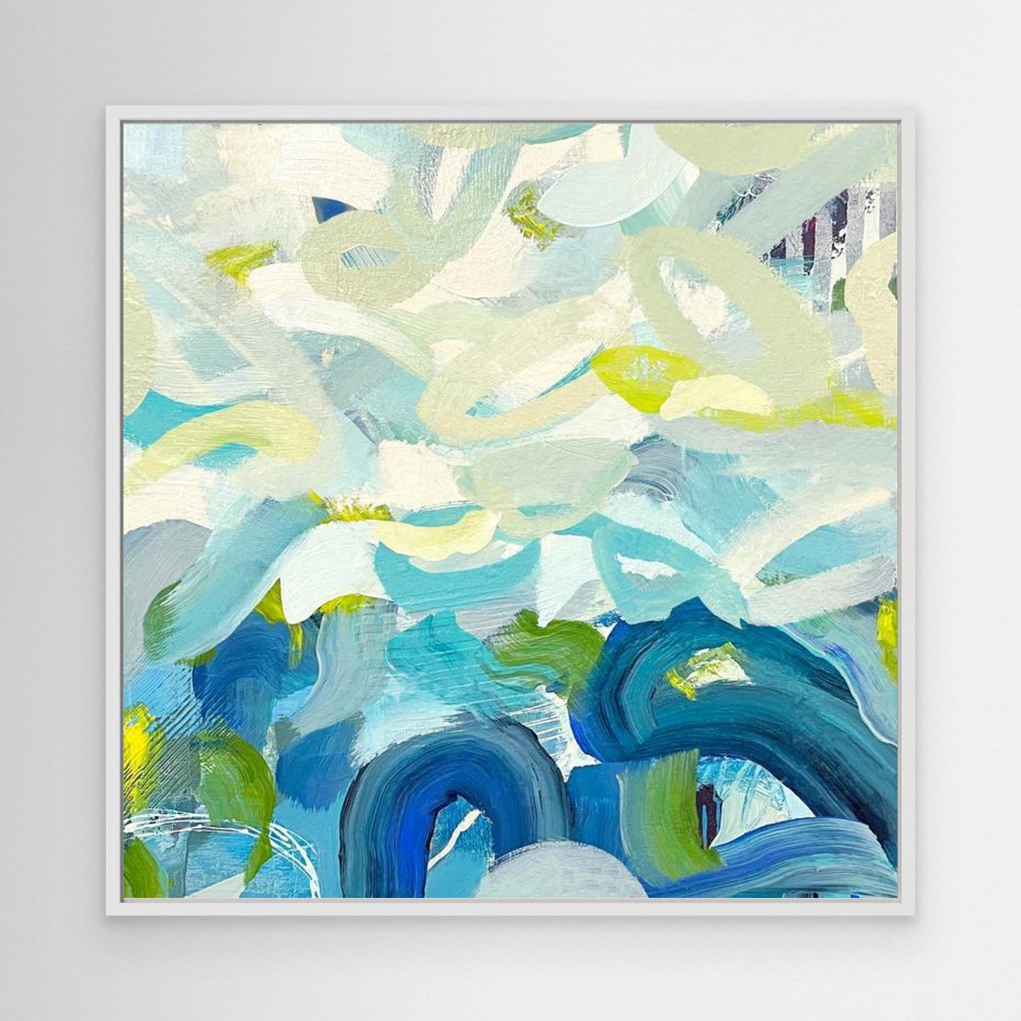 Outward Expression blue abstract framed canvas print in white frame on white wall.