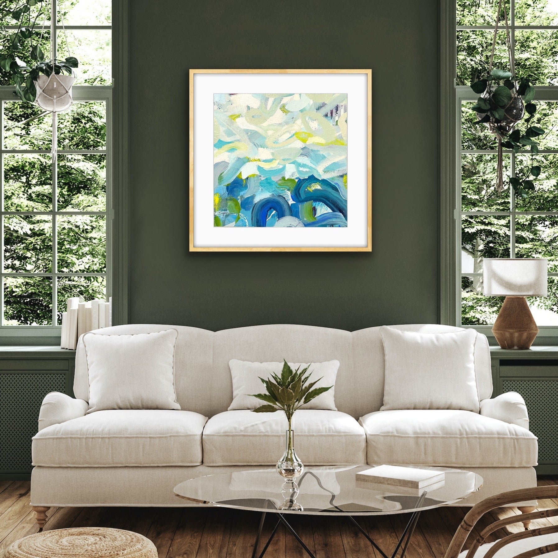 Living room with a white sofa, abstract art print "Outward Expression" framed print by Alison Gilbert Art on the wall, and decorative elements.