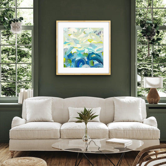 Living room with a white sofa, abstract art print "Outward Expression" framed print by Alison Gilbert Art on the wall, and decorative elements.