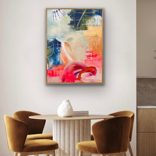 Modern interior with abstract Alison Gilbert canvas print 'Red Moon Rising' on the wall above a dining table and chairs.
