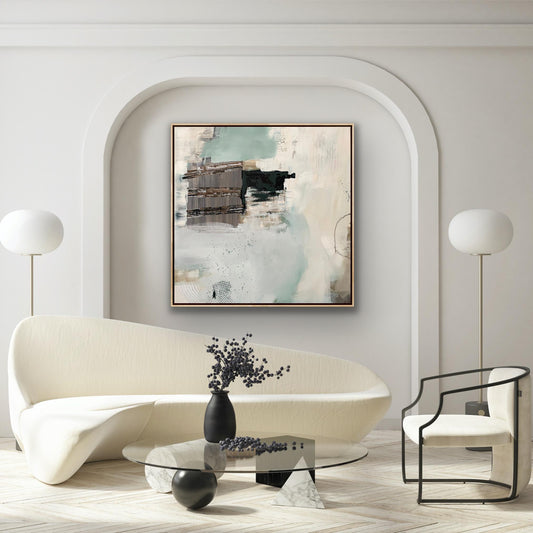 Modern living room with a white sofa, glass coffee table, and abstract Alison Gilbert canvas print 'Seafoam's Echo' on the wall.
