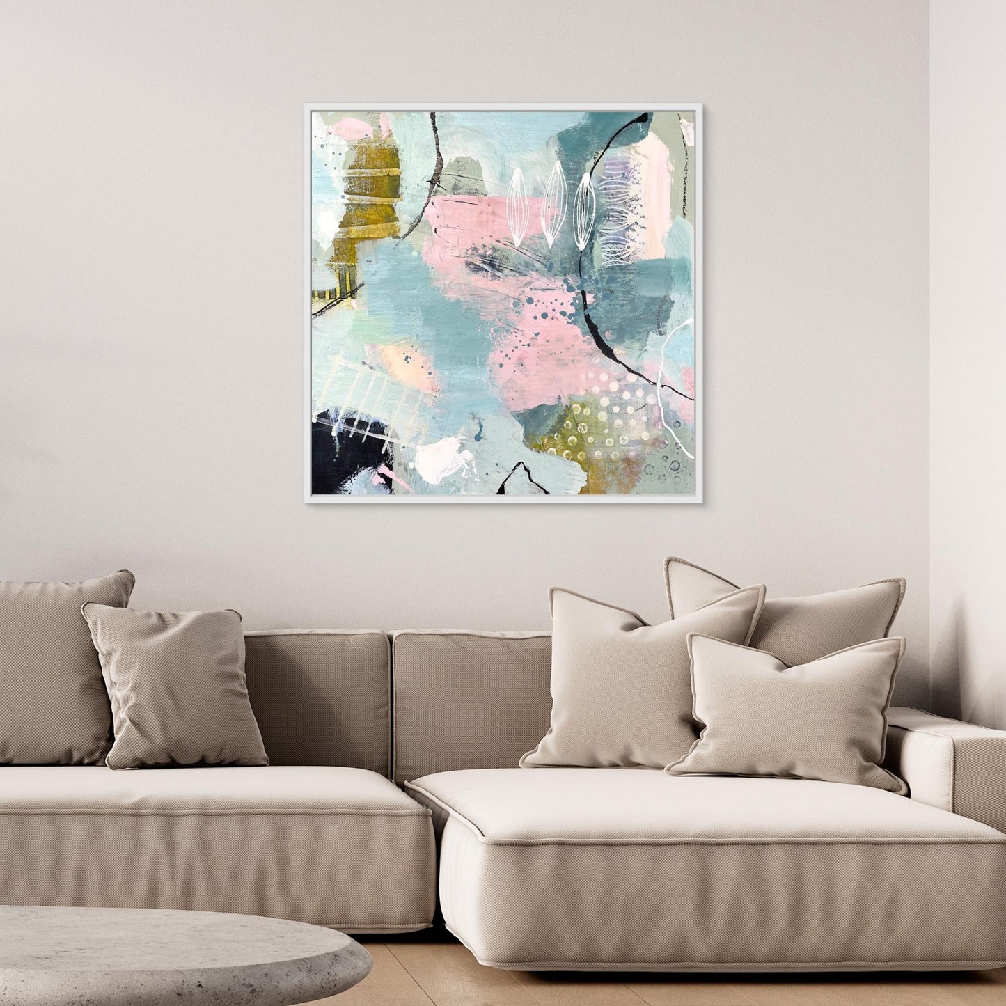 Abstract canvas print 'Shallow Pool'on a wall above a sofa in a living room.