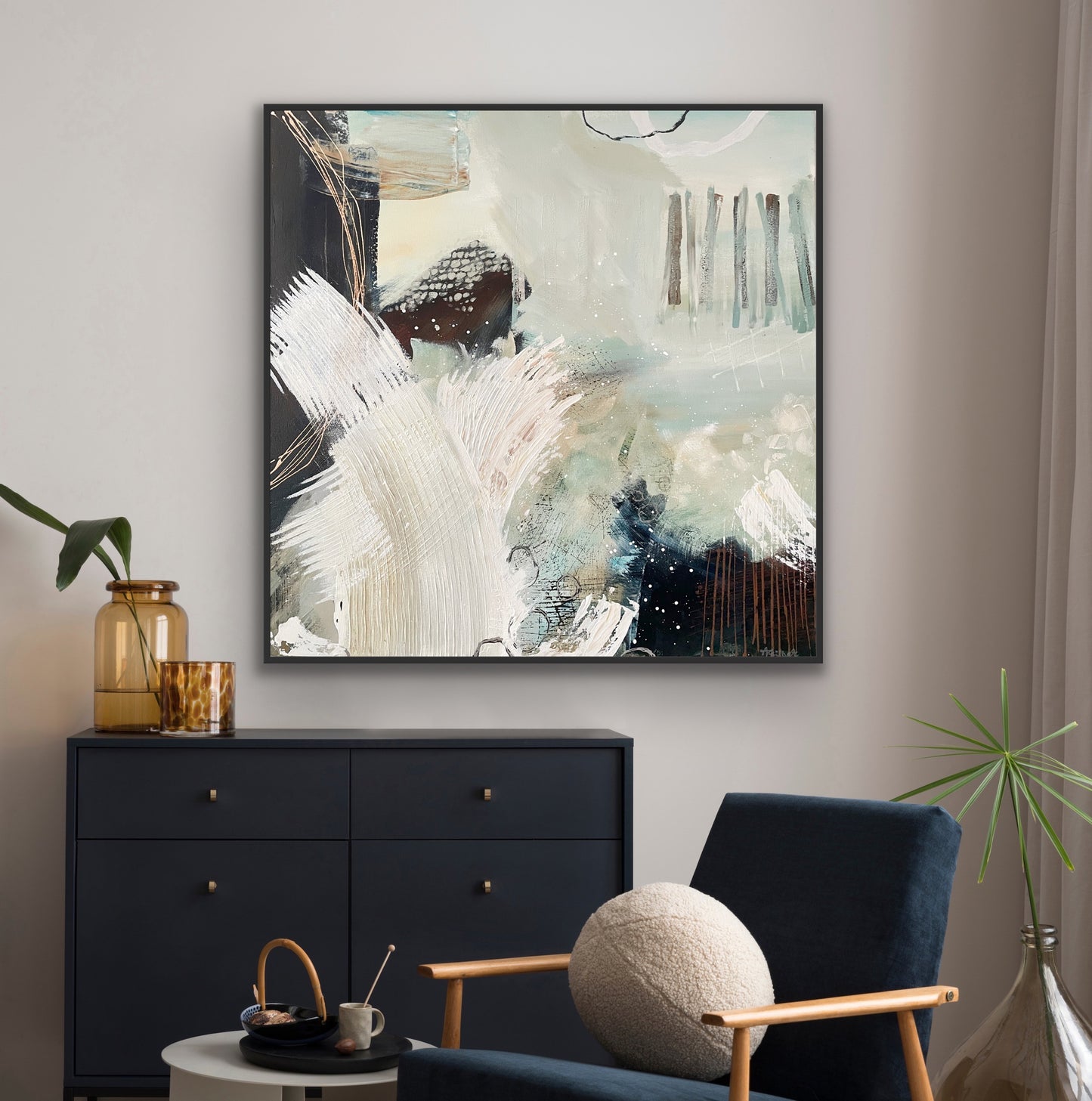 Abstract canvas print 'Siren's Swell' by Alison Gilbert Art on a wall above a black dresser with a blue chair and decorative items.