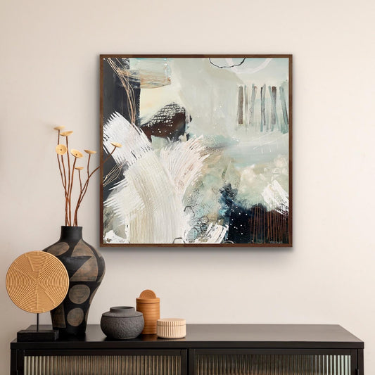 Framed abstract canvas print 'Siren's Swell' by Alison Gilbert Art on a wall above a console table with decorative items.