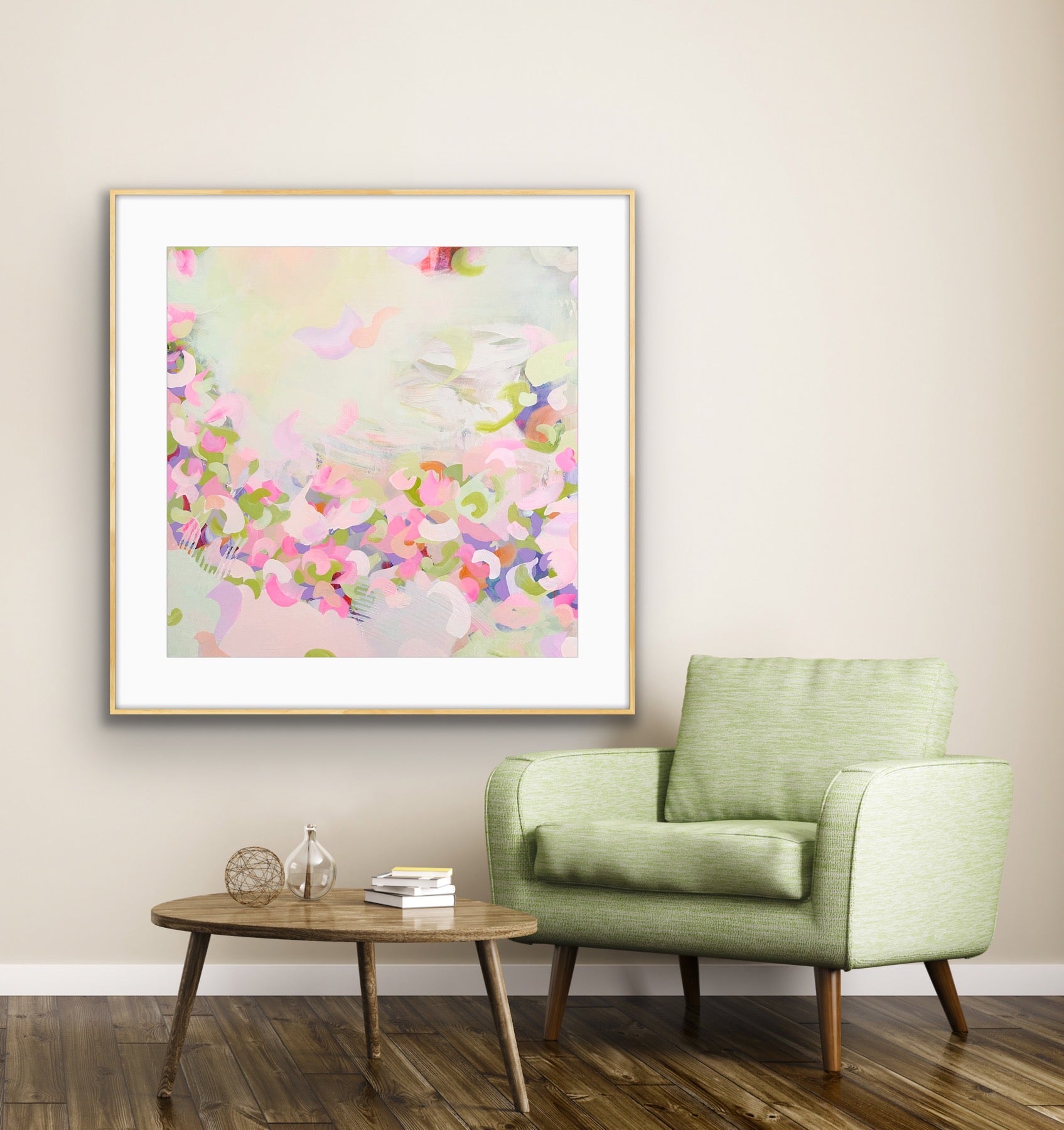 Framed pastel coloured abstract print "Spring Serenade" on a wall above a green armchair in a living room.