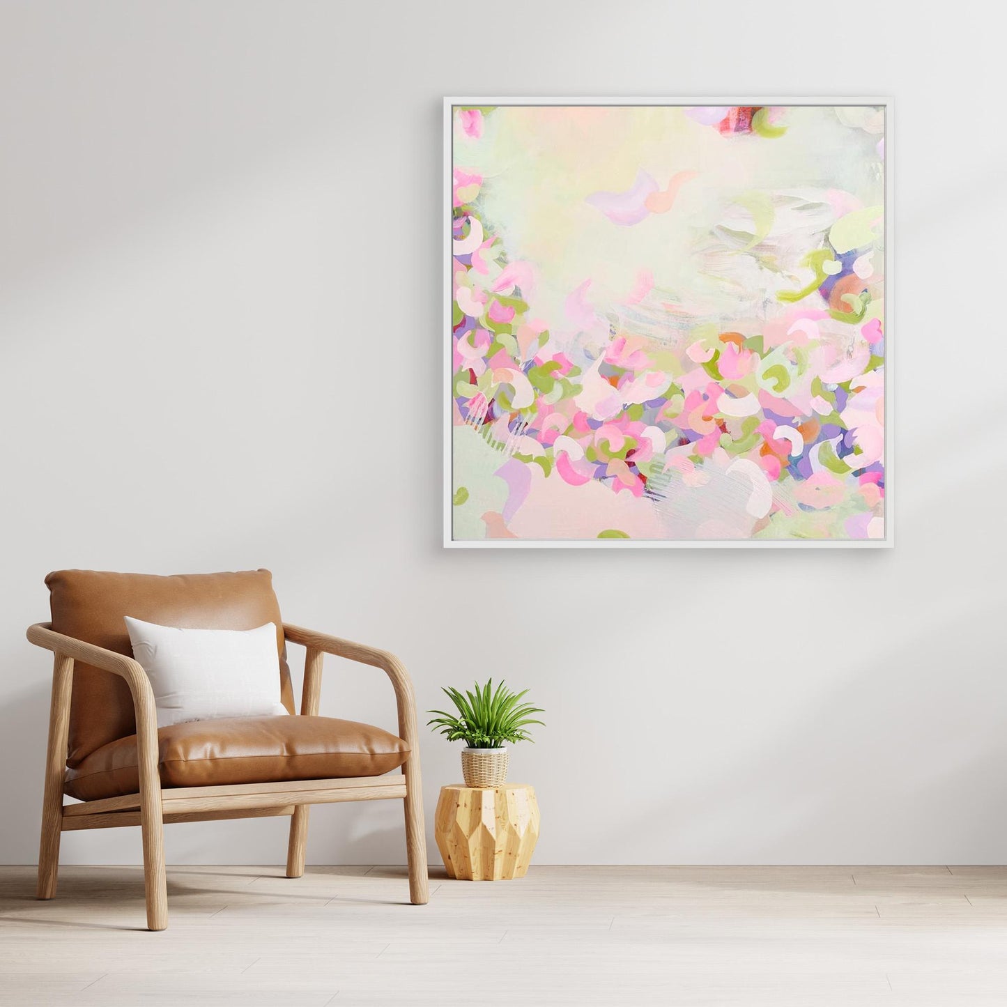 Framed pink abstract canvas print 'Spring Serenade' on a wall above a wooden console table.