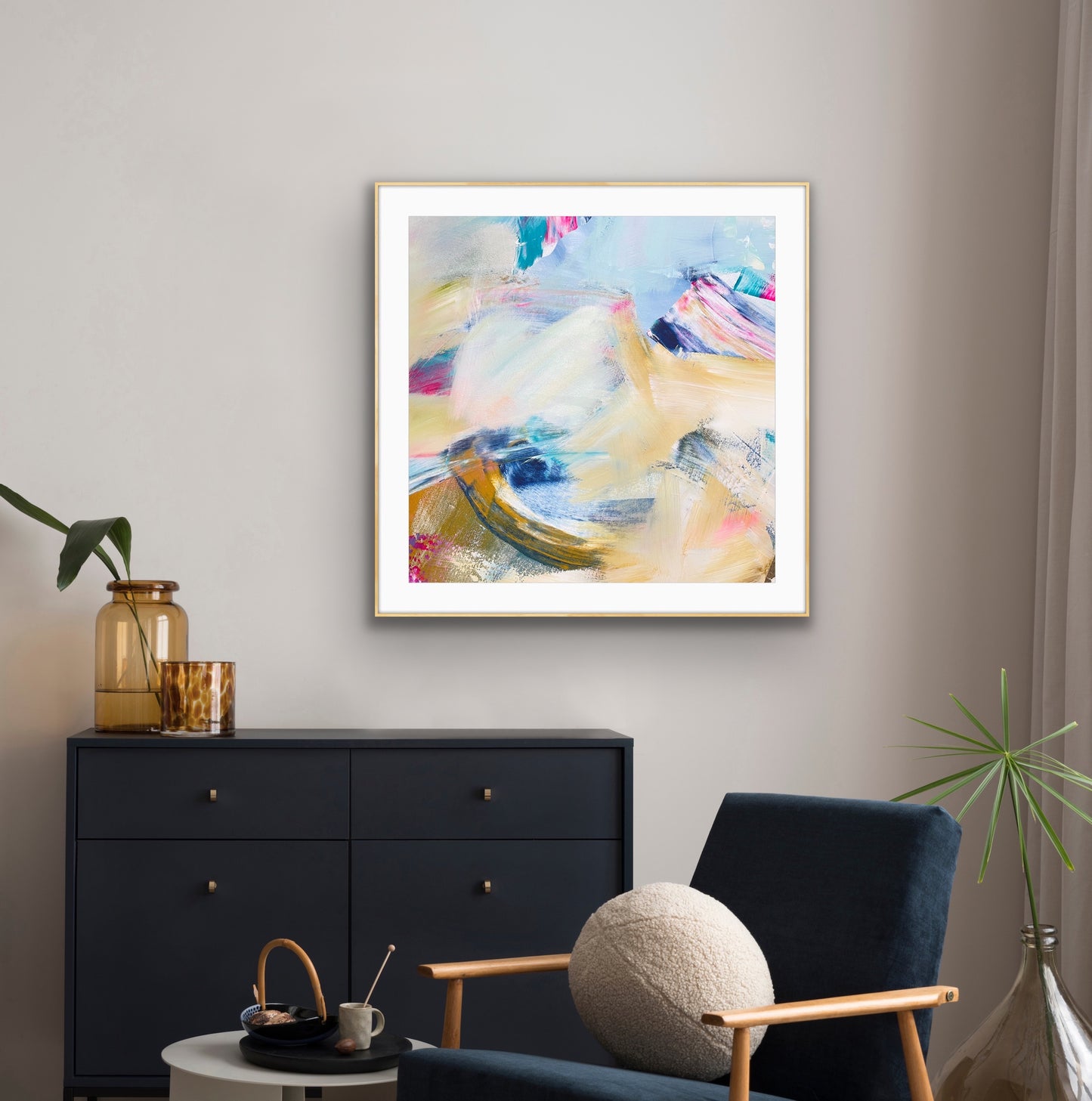 Framed abstract giclee print "Summer Breeze"  on a wall above a black dresser with decorative items.
