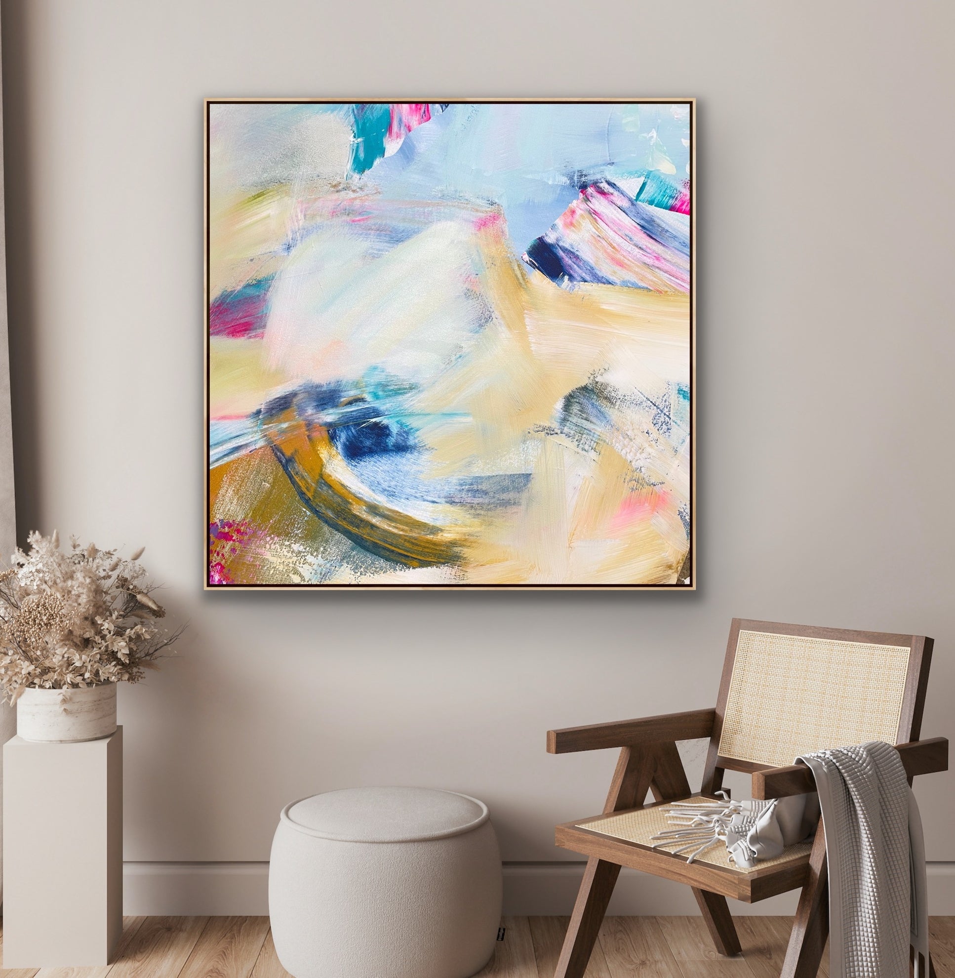 Abstract Alison Gilbert canvas print 'Summer Breeze' on a wall above a chair and side table in a room.