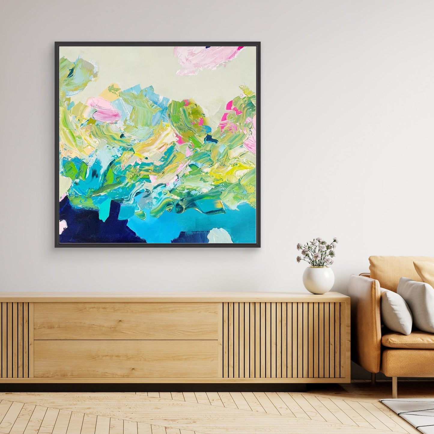 Colourful abstract canvas print 'Turbulence'  from Alison Gilbert in a modern living room with a brown chair and plant. 