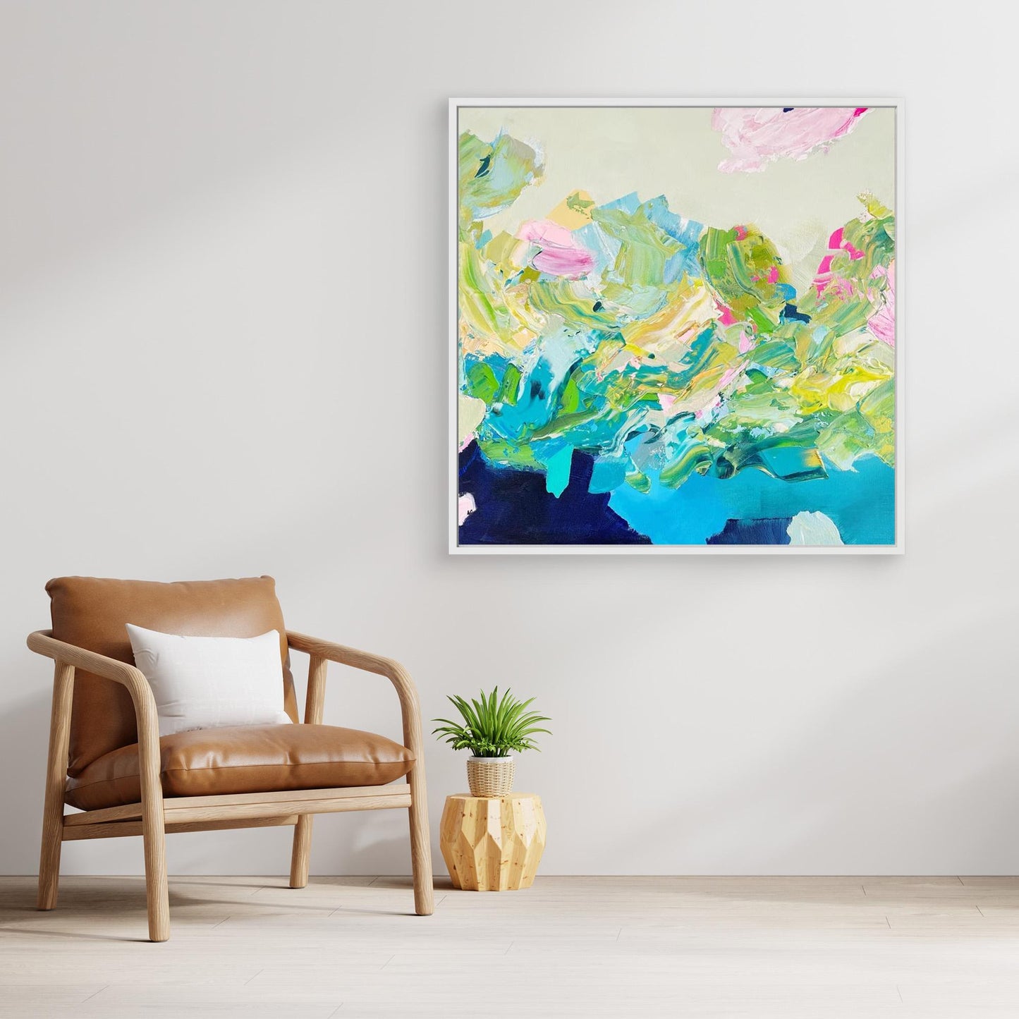 Colourful abstract canvas print 'Turbulence'  from Alison Gilbert in a modern living room with a brown chair and plant. 