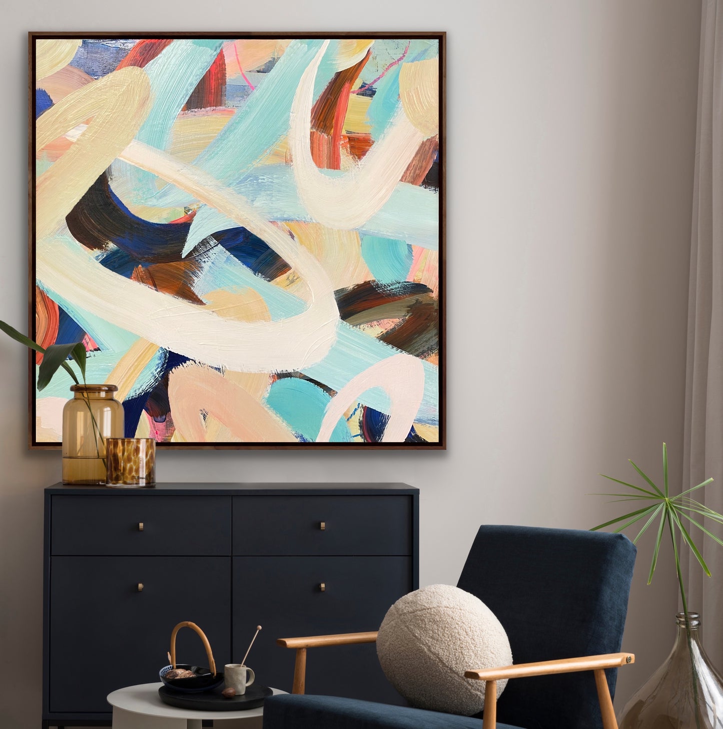 Abstract art canvas print 'Twist & Shout' from Alison Gilbert Art on a wall above a black cabinet with a blue armchair and decorative items. 