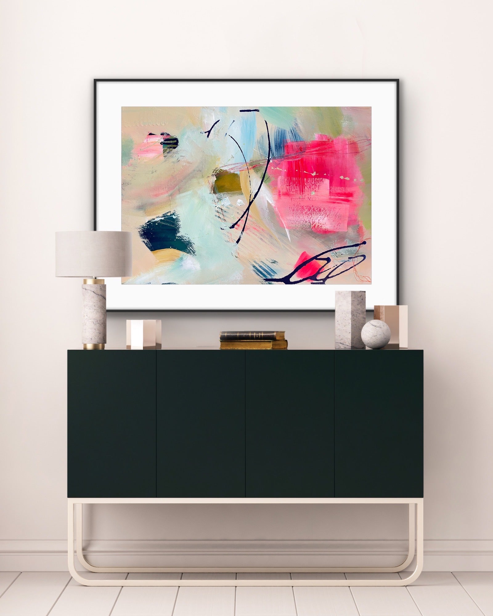 'Unexpected Arrival' Framed Print on Paper on a wall above a black cabinet in a room.