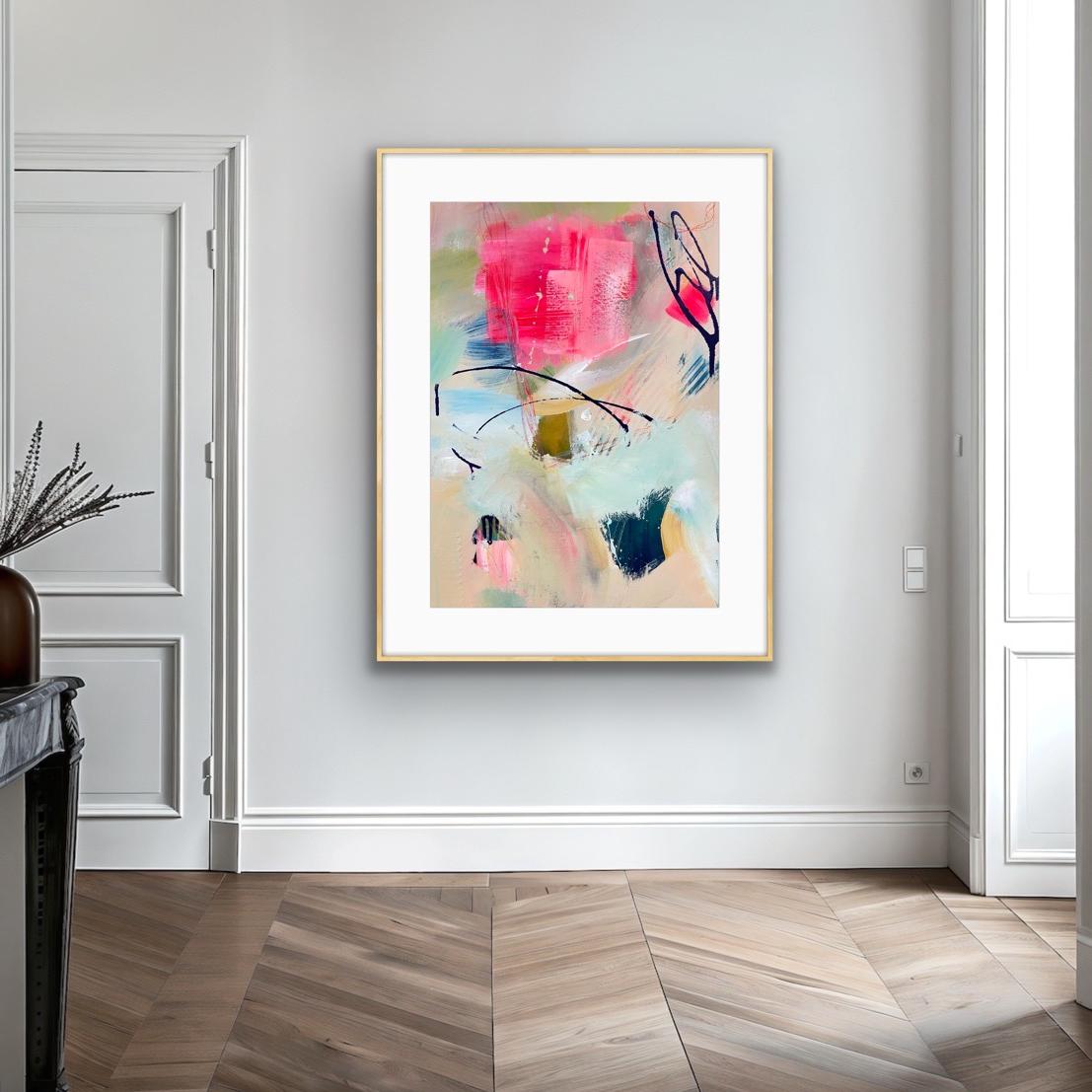 Abstract art print in a gold frame on a wall with wooden flooring and white walls.