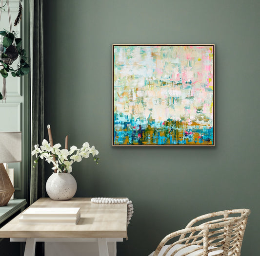 Abstract Alison Gilbert canvas print 'Where the Light Falls' on a gray wall above a table with a vase and books.