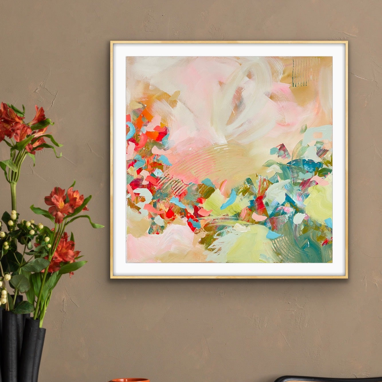 Abstract giclee print "Whispers of a  New Day" on a wall above a table with a vase, mug, and book.