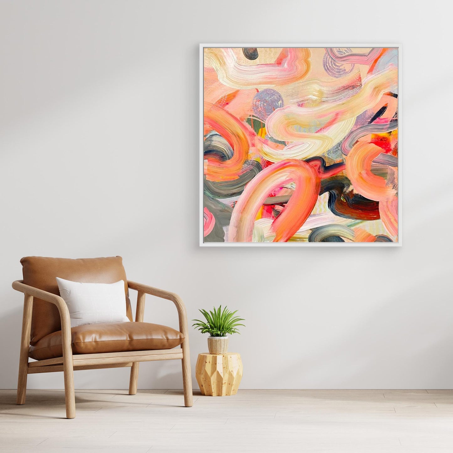 Abstract Alison Gilbert canvas print 'Wurlitzer' on a wall above a brown armchair with a white pillow and a small plant.